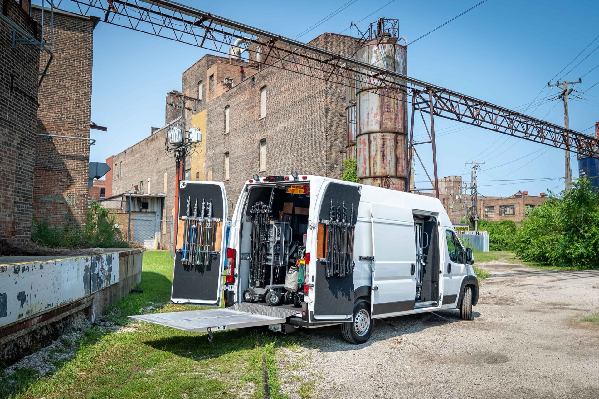 2 ton production truck parked outside a Chicago industrial building with the rear doors open showing the loaded lighting and grip package