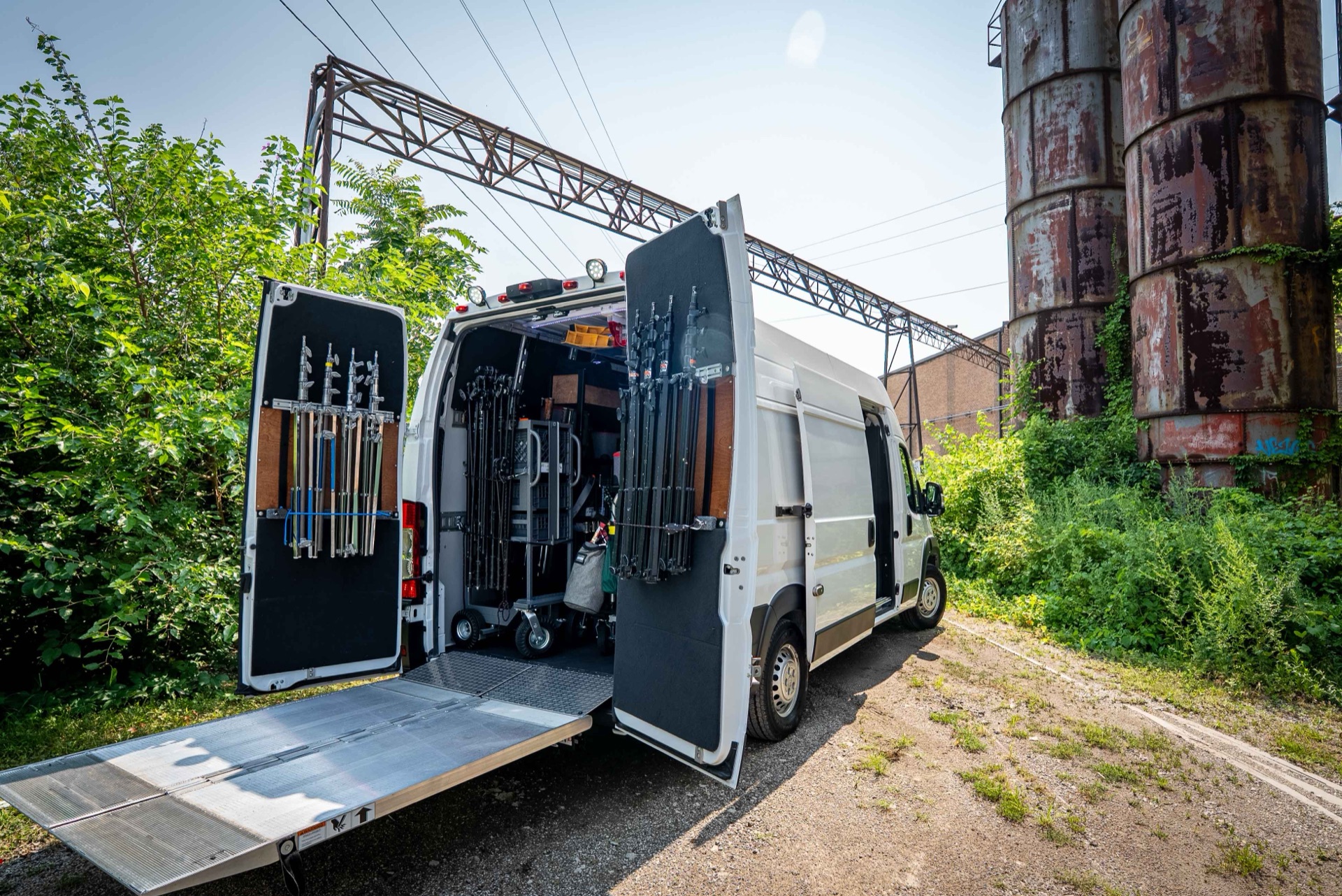 Hydraulic Tommy Gate liftgate lowered to the ground at the back of the 2 ton grip truck, ready to roll carts and cases aboard